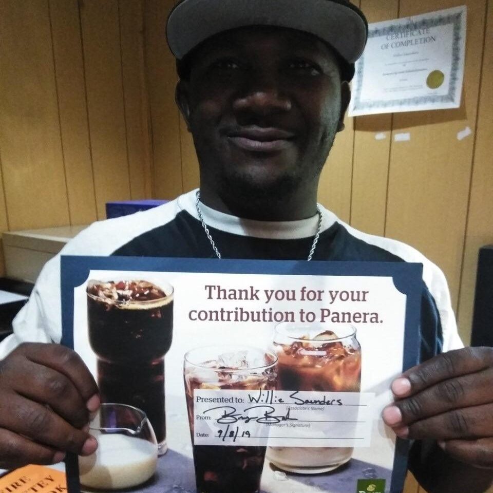 Willie holds a certificate of appreciation for his work at Panera Bread.
